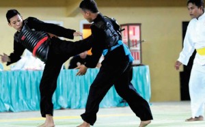 TENDANG: Salah satu pertandingan pencak silat kategori putra di GOR Tawang Alun Banyuwangi kemarin.
