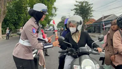 sambut-hari-jadi,-polwan-di-banyuwangi-bagi-bagi-cokelat-dan-bendera-ke-pengguna-jalan